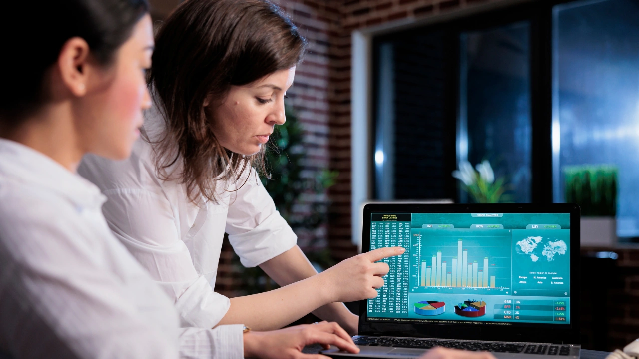 Two women looking at a compliance gap assessment